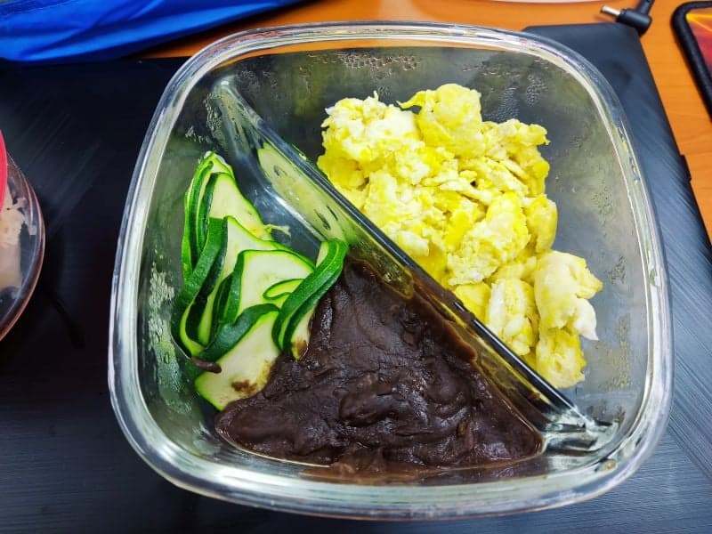 Scrambled egg, refried beans and zucchini