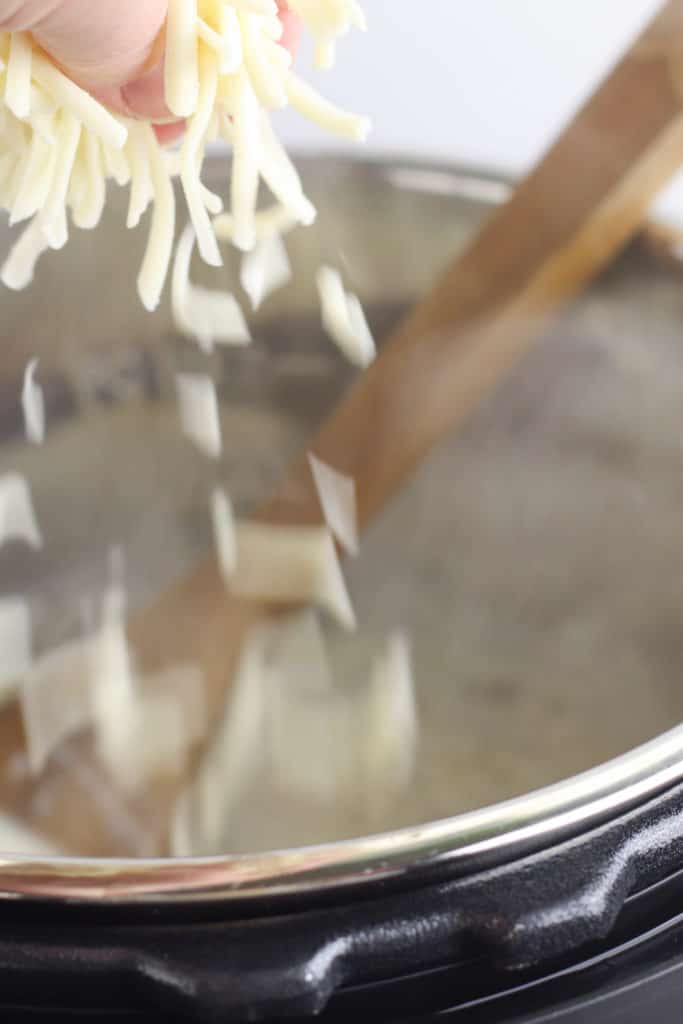 Shredded cheese dropping on cheesburger soup