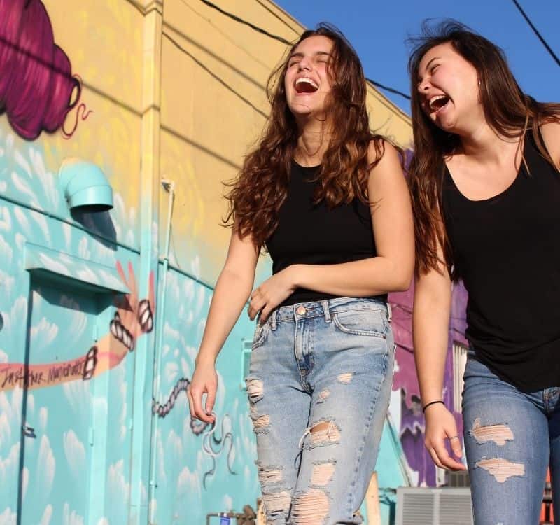 2 women laughing outside