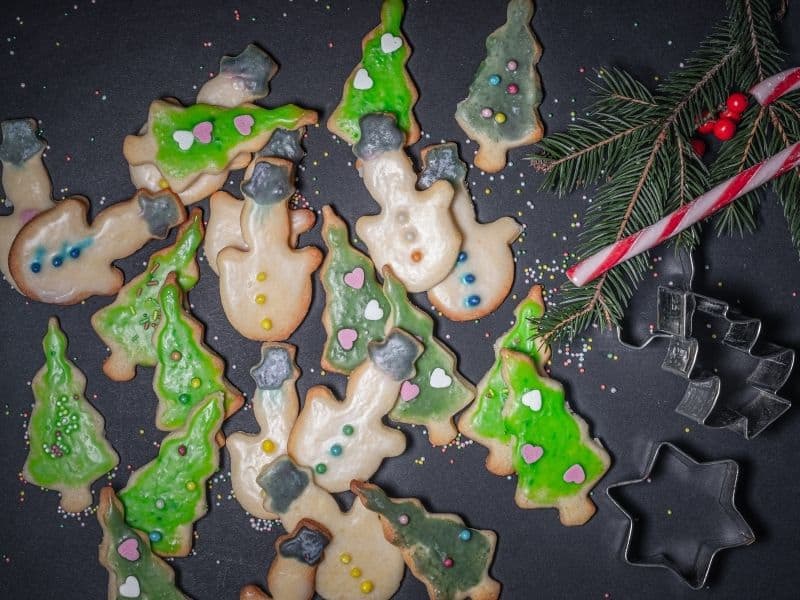 green and white decorated christmas cookies in different shapes