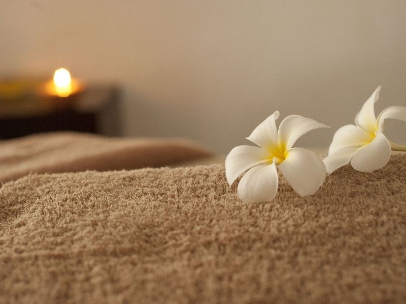a towel on a surface with a flower on it