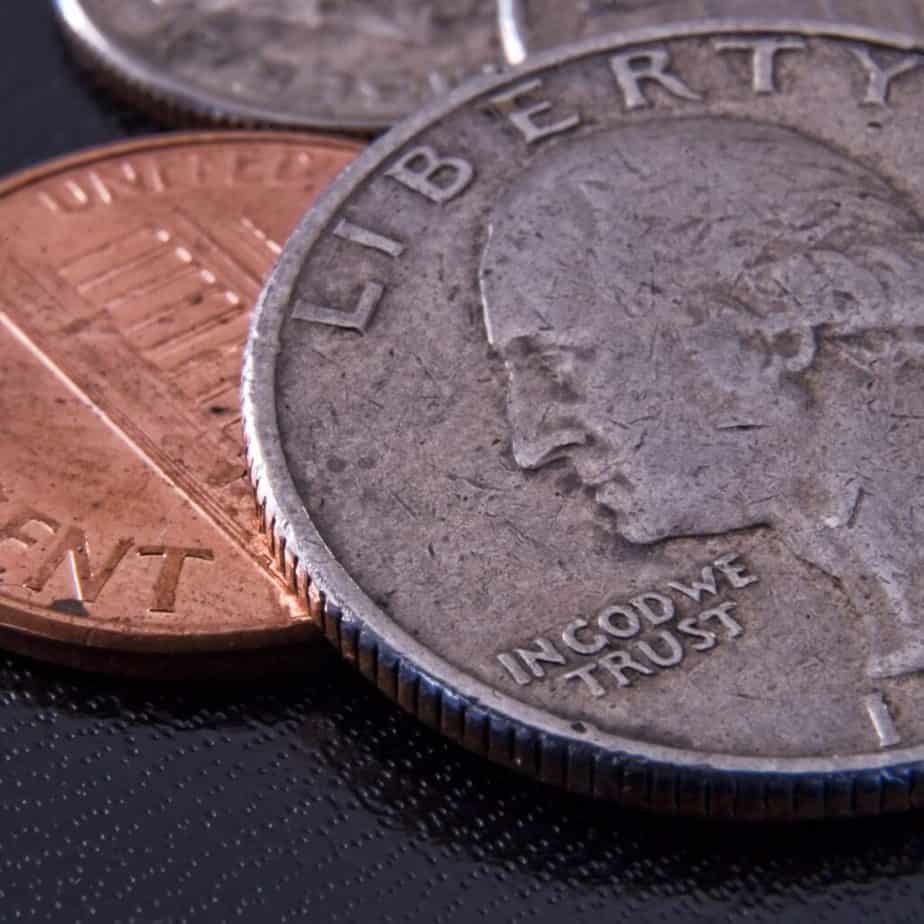 a US quarter with a penny in the background