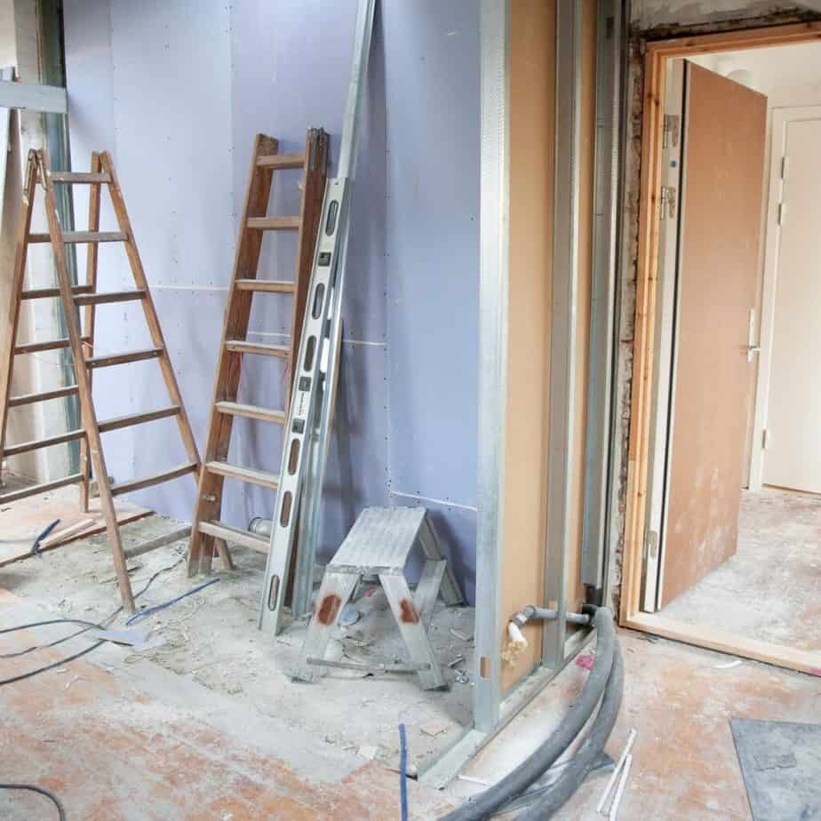 a room being painted with ladders