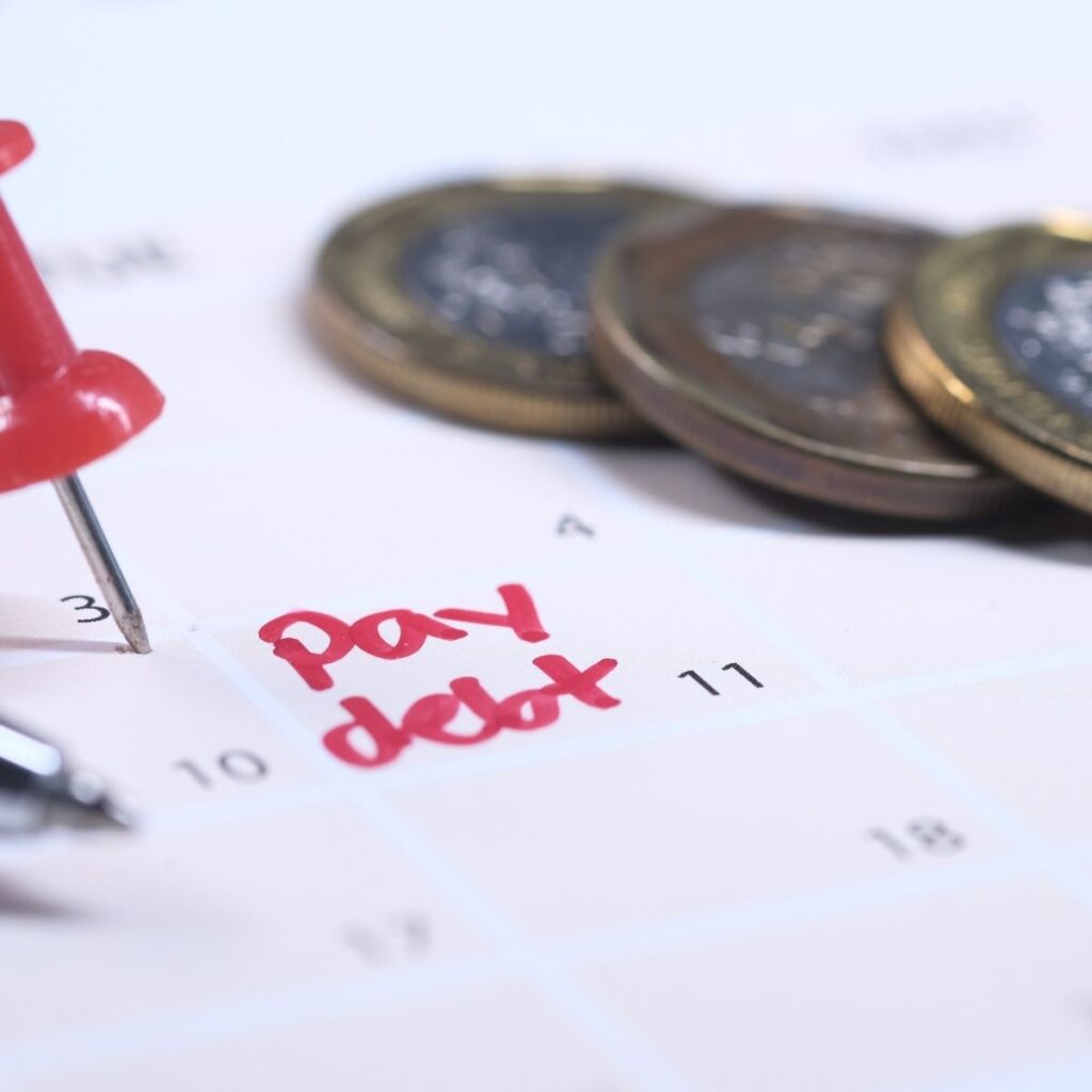 a calendar with the words "pay debt" in red marker
