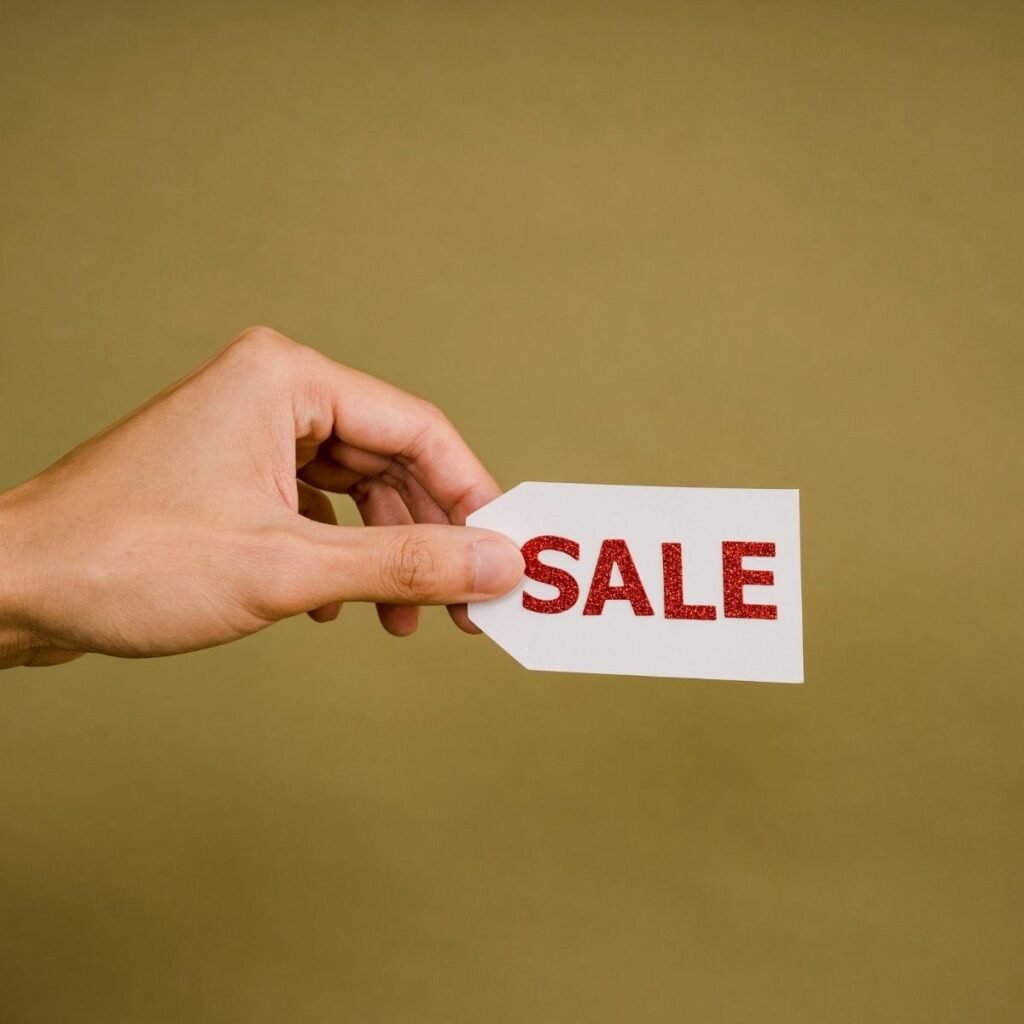 a hand holding a sale tag