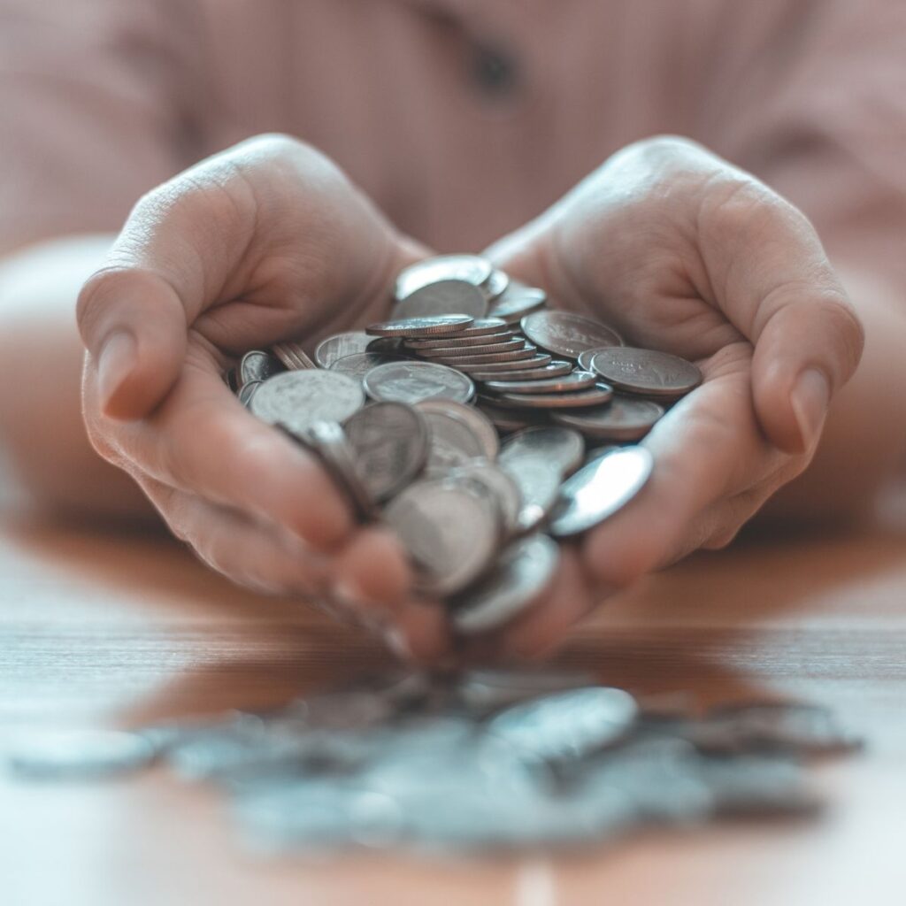 hands holding silver coins
