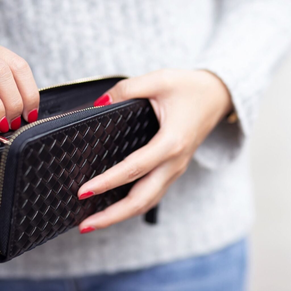 a woman checking the inside of her wallet