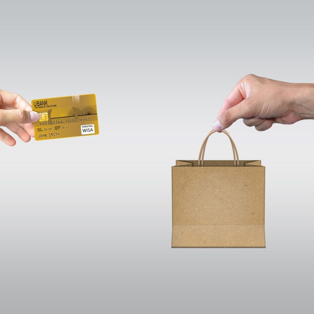 hands exchanging a credit card for a bag