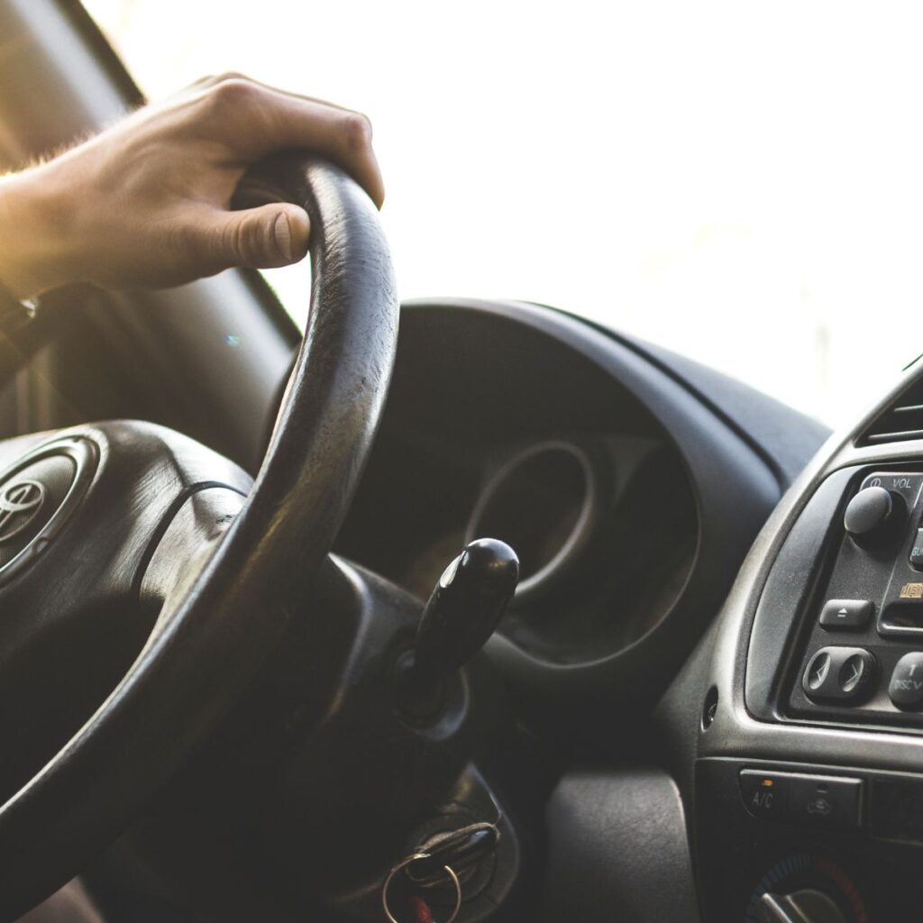 hand on a vehicle steering wheel